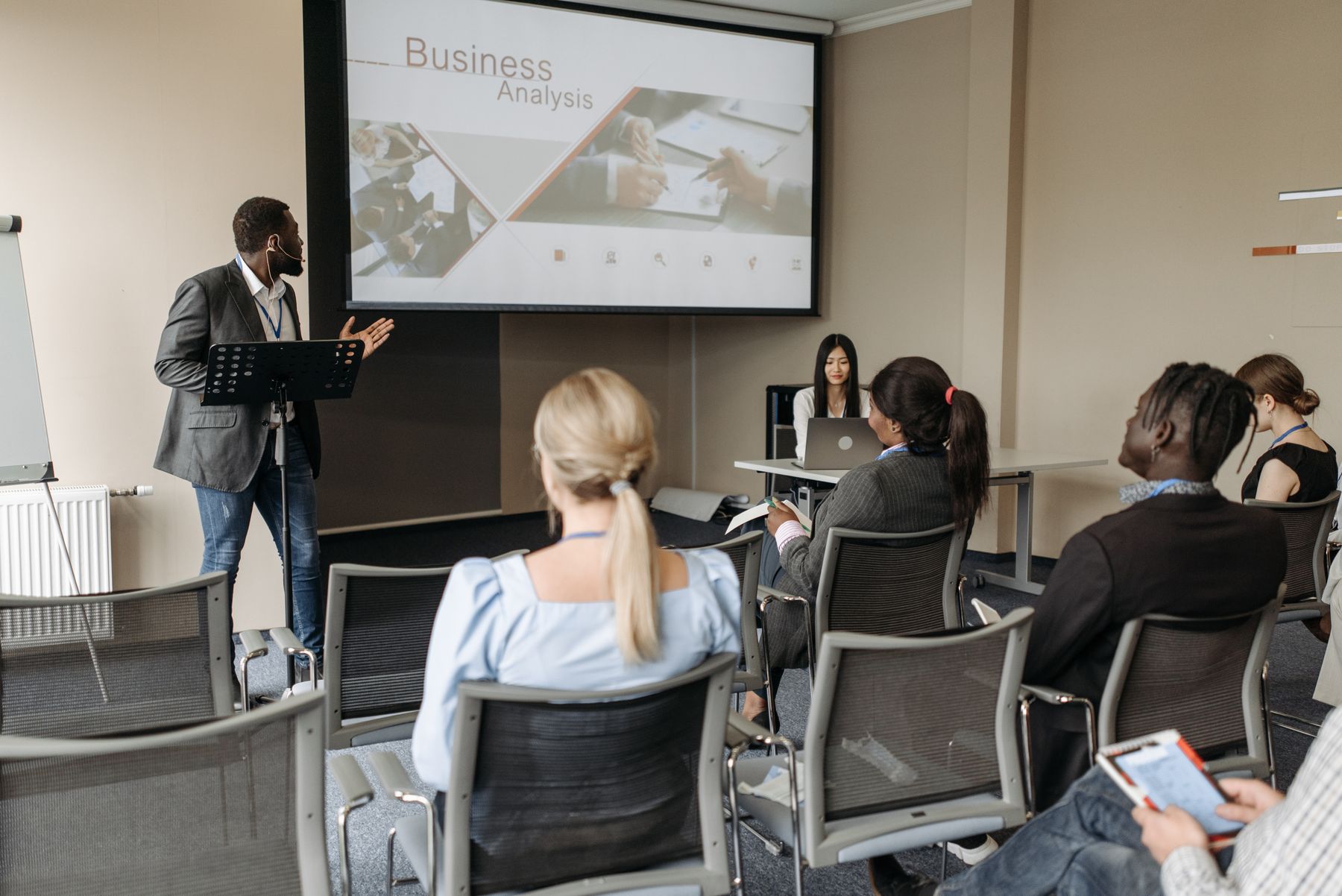 Presenter leading a seminar for a seated group in a corporate training room