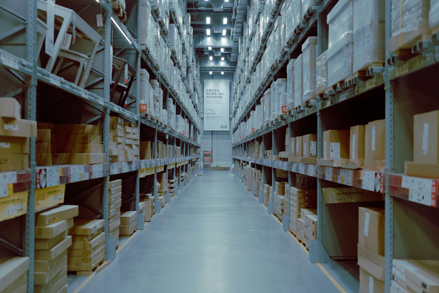 A warehouse aisle lined with racked and palletised stock