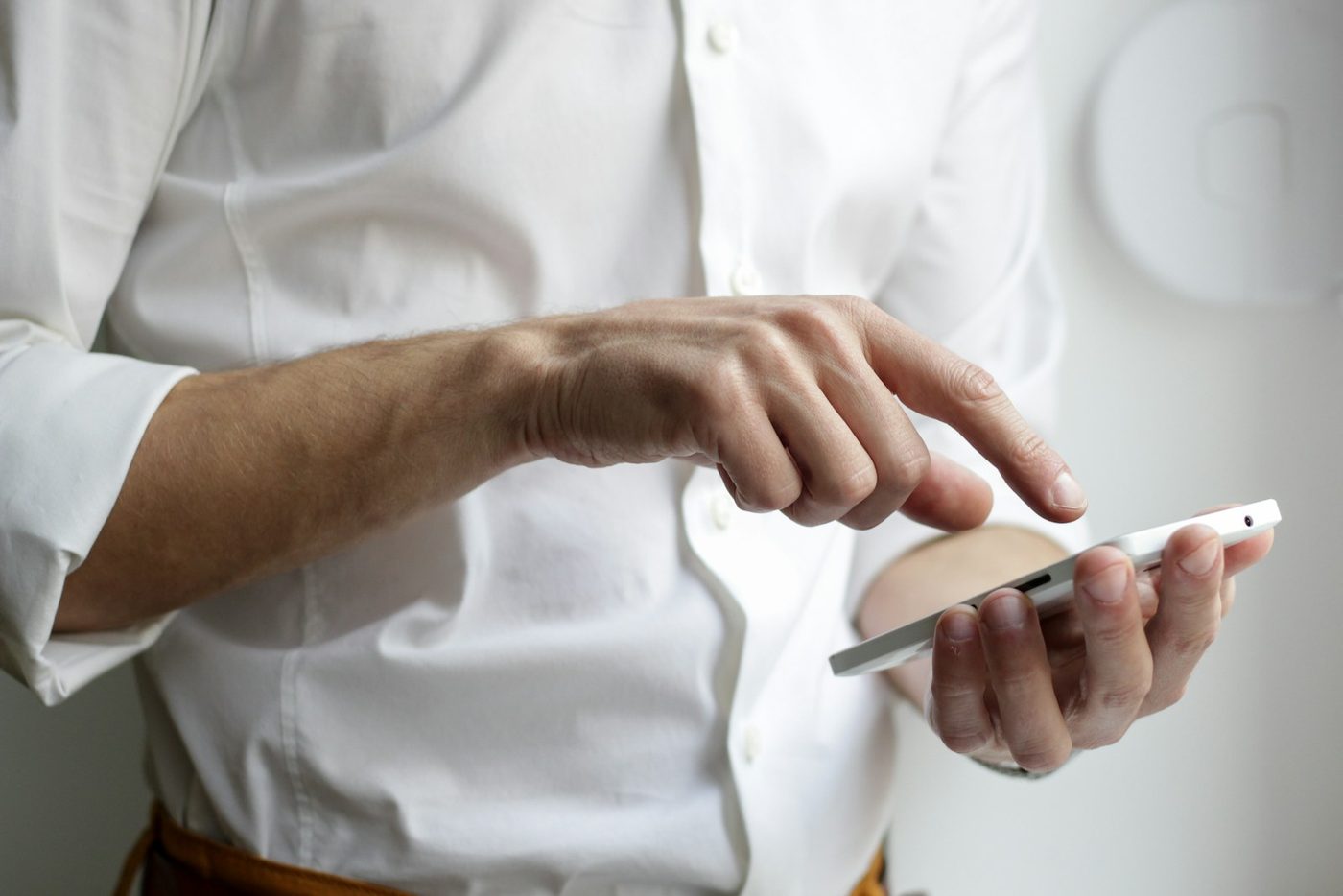 A person using an application on a smartphone held in both hands