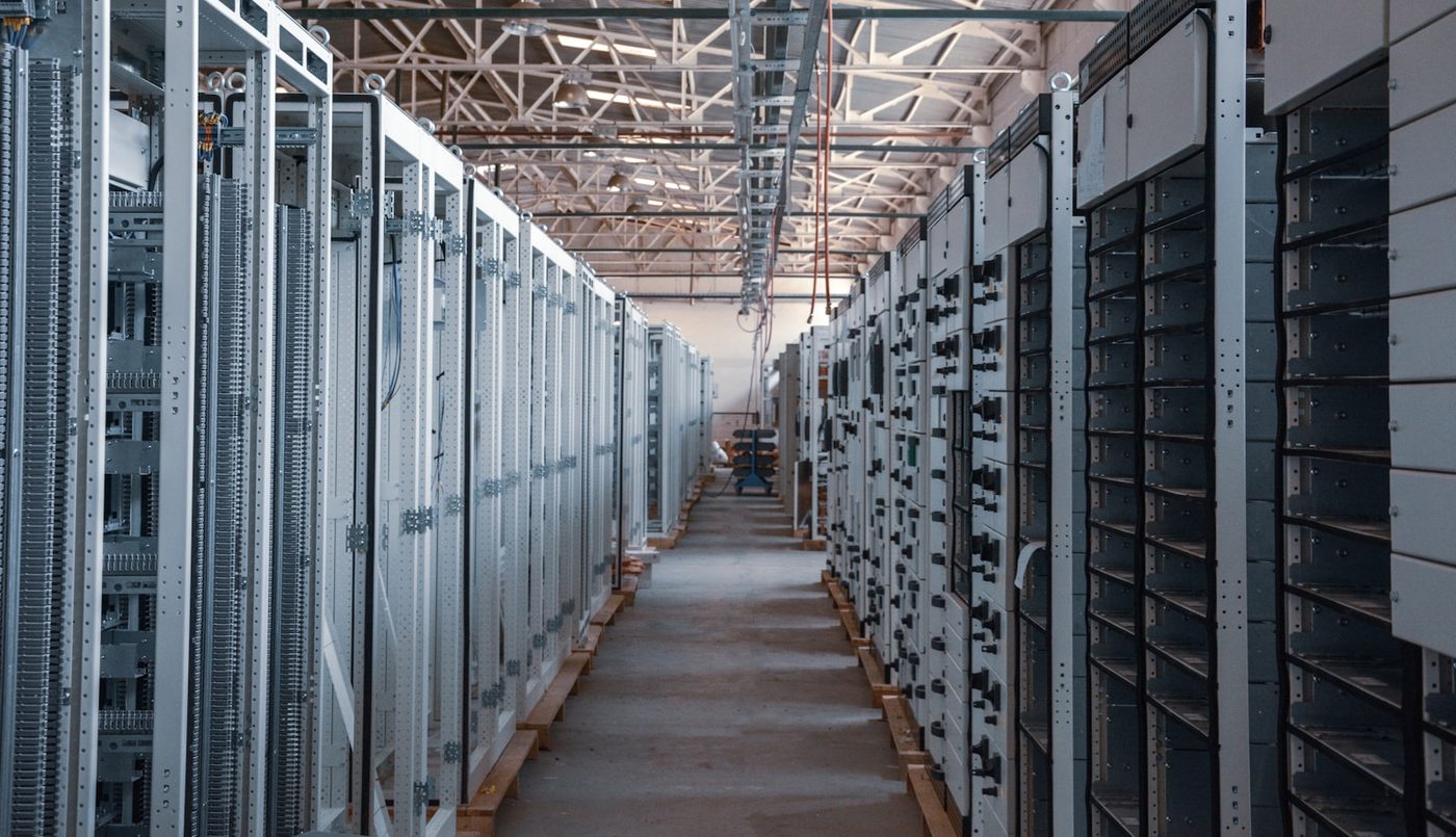 An equipment aisle of racked servers in a data hall